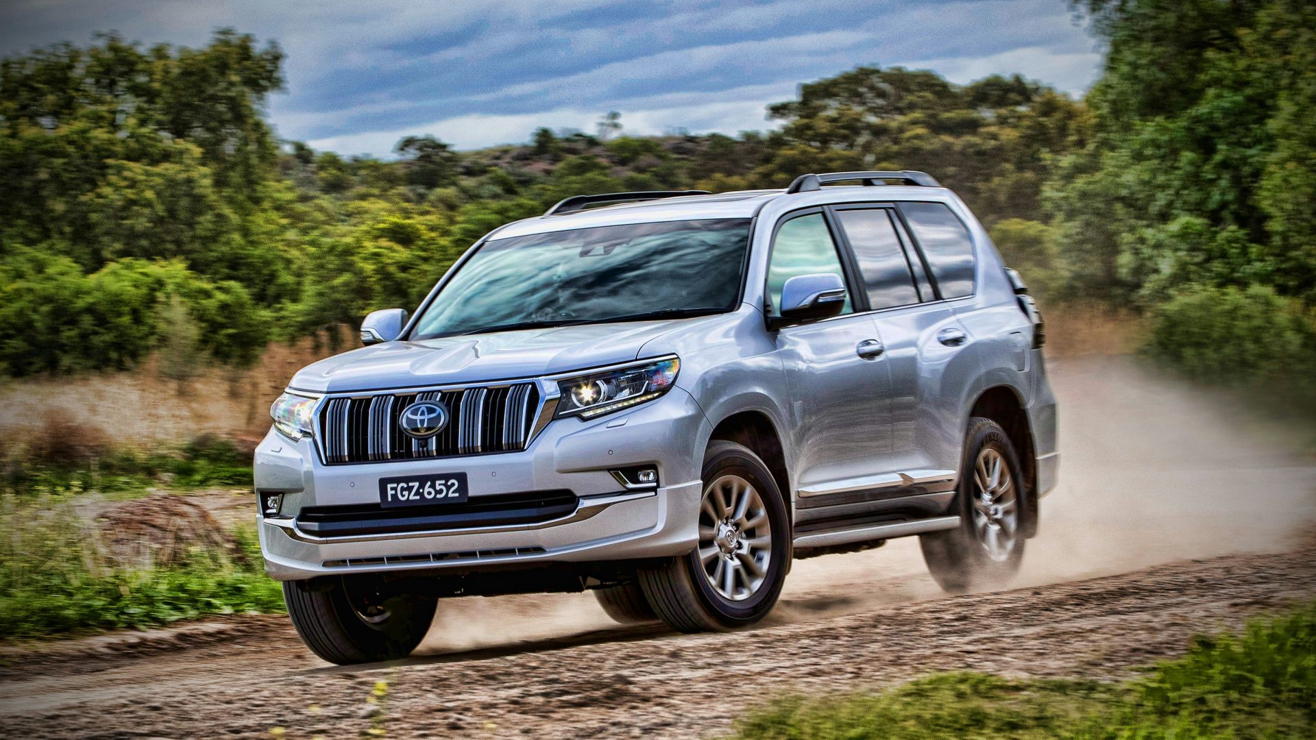gray mercedes benz suv on brown dirt road during daytime