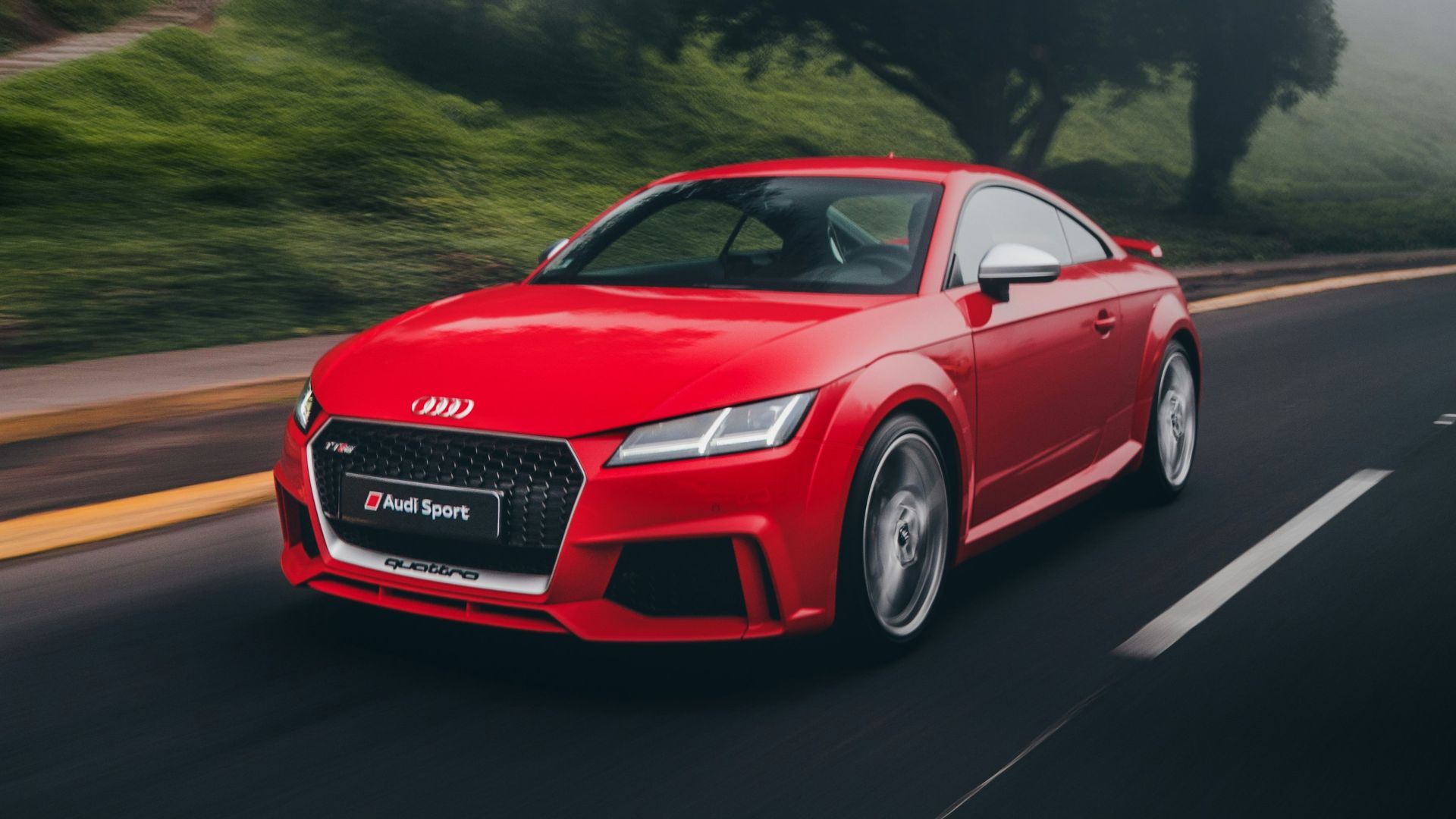 red Audi coupe on road near trees at daytime