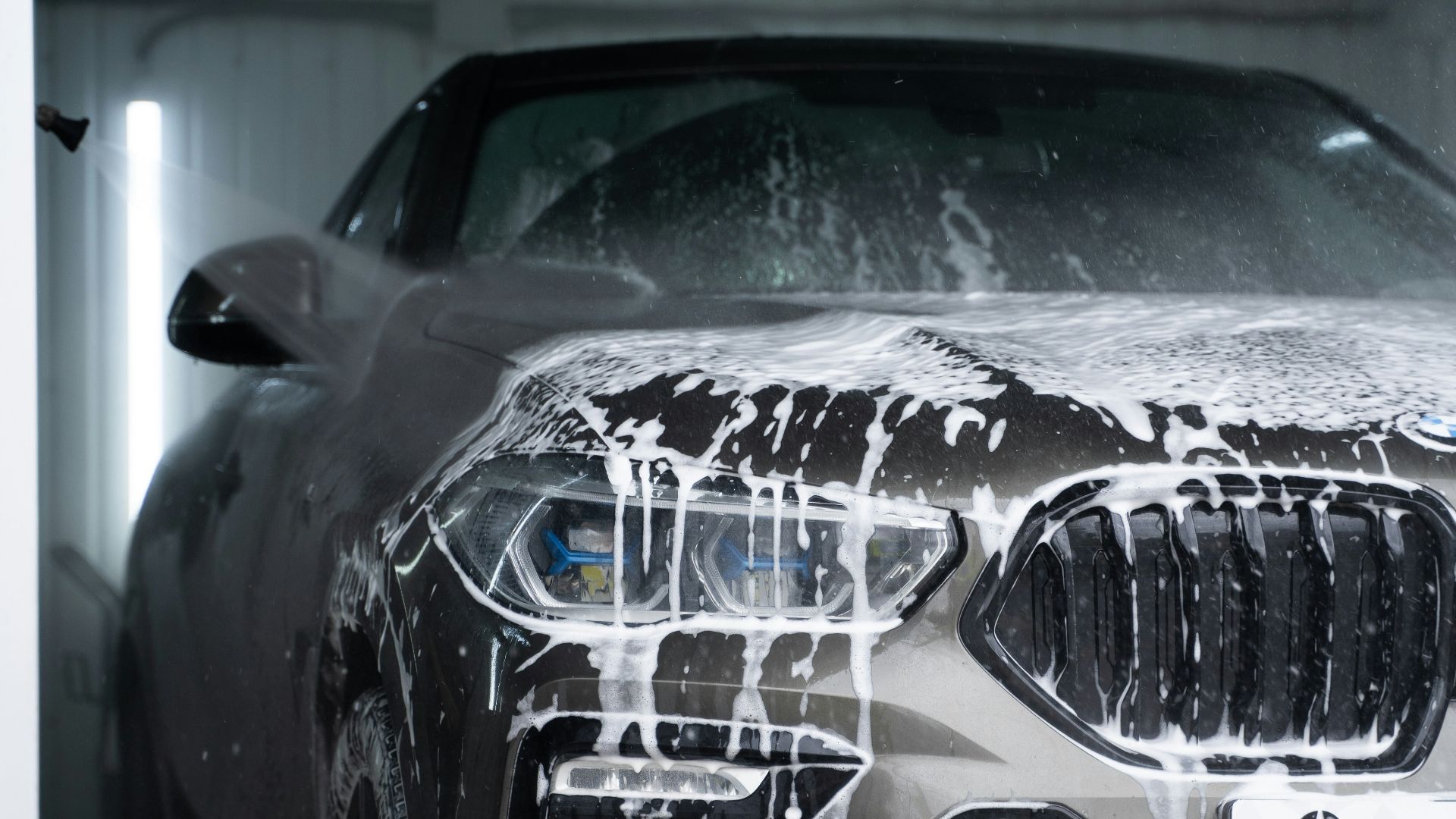 a car is covered in snow in a garage