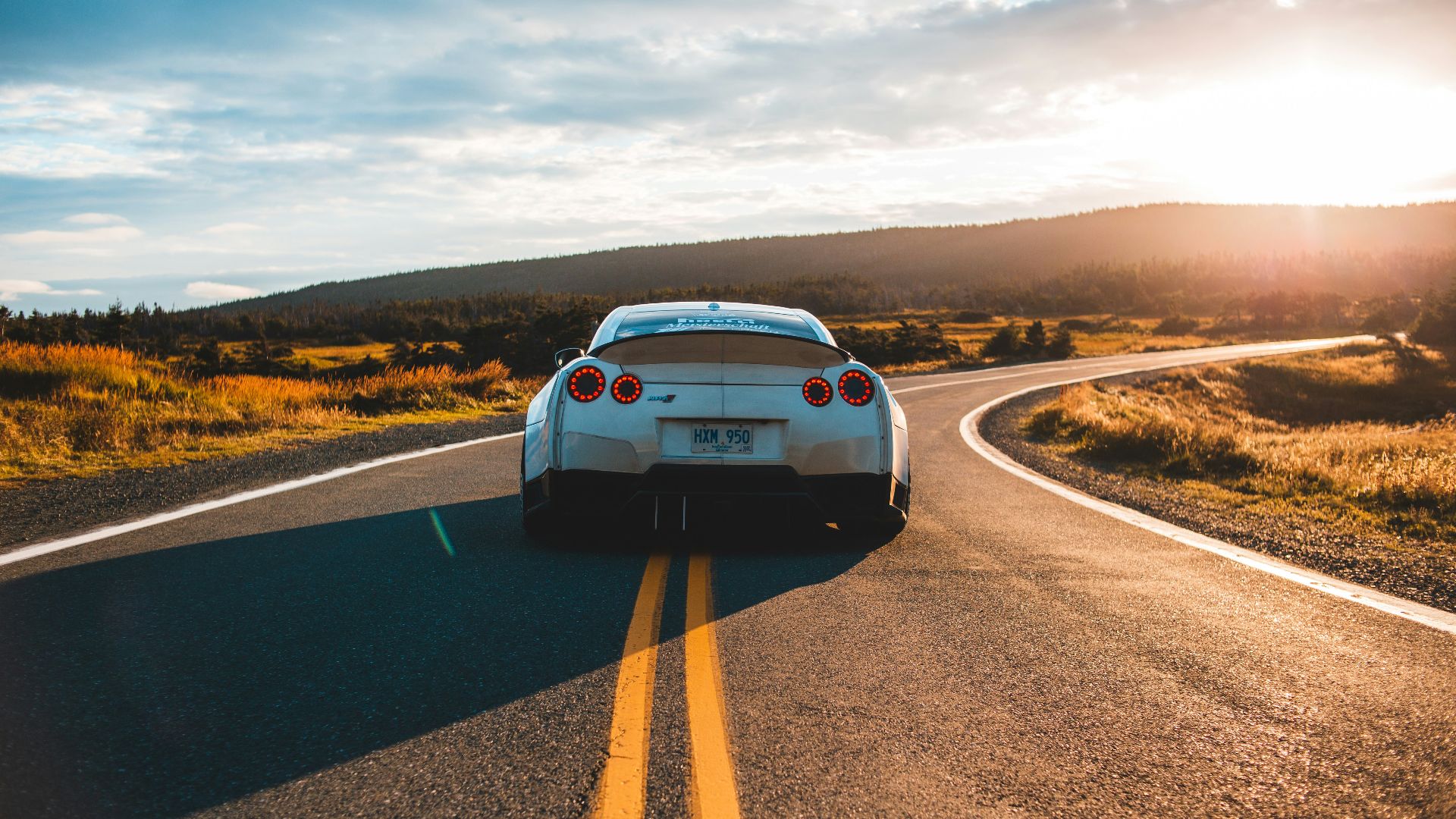 silver sports coupe on asphalt road