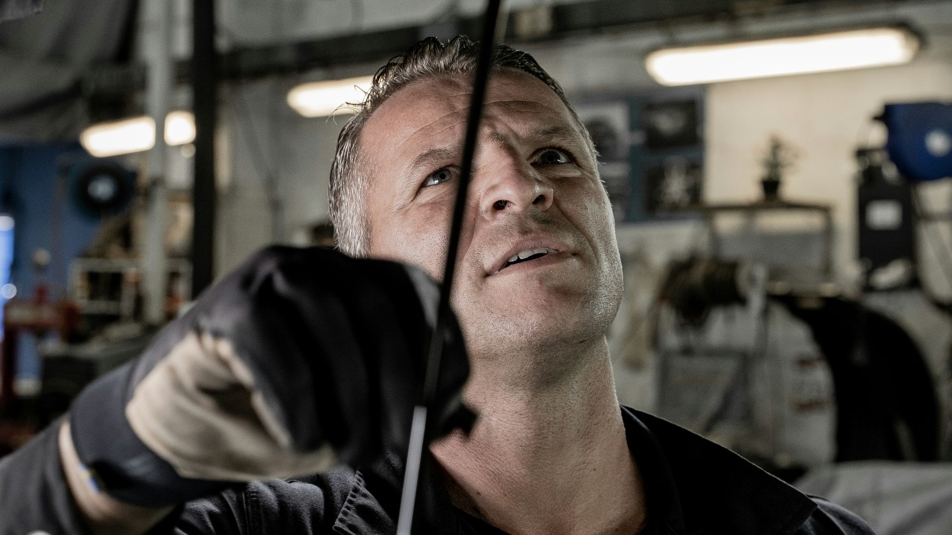 a man working on a car in a garage