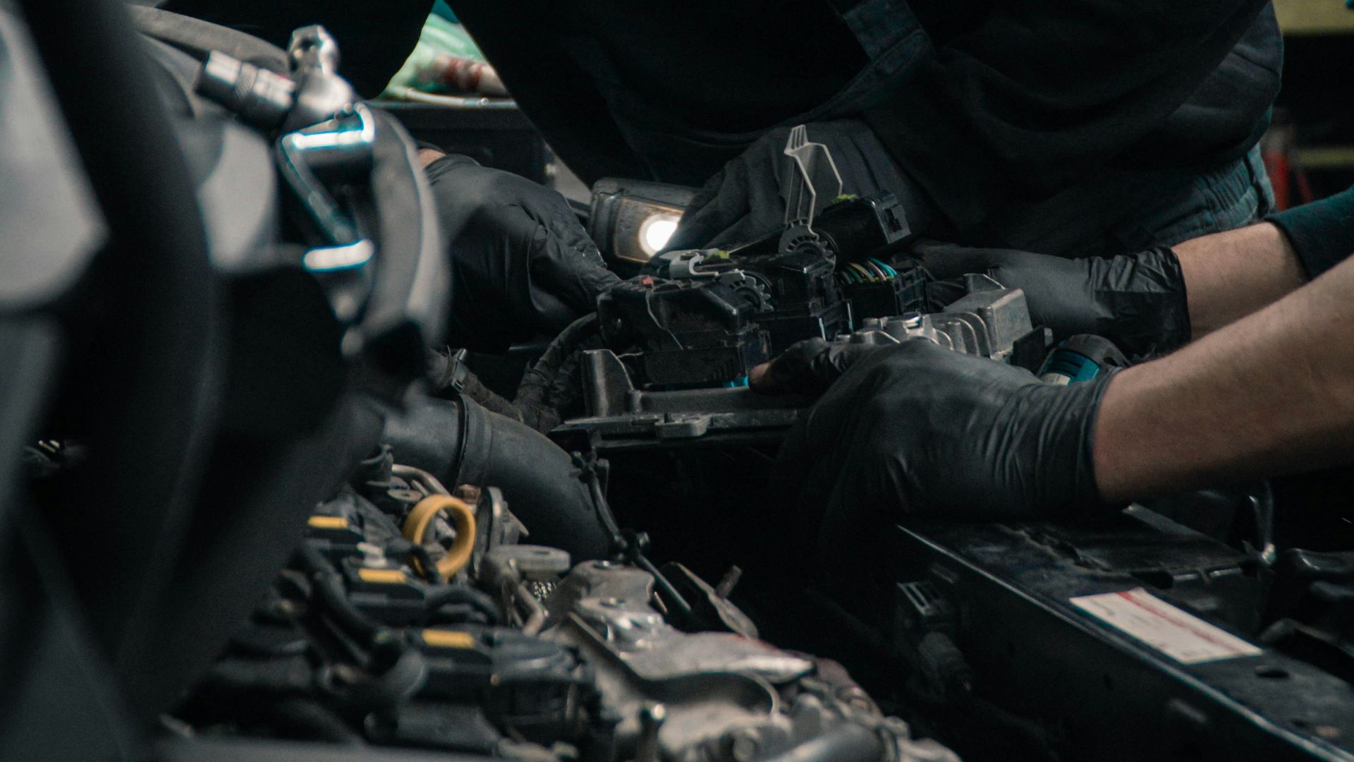 man in black jacket and blue denim jeans riding motorcycle