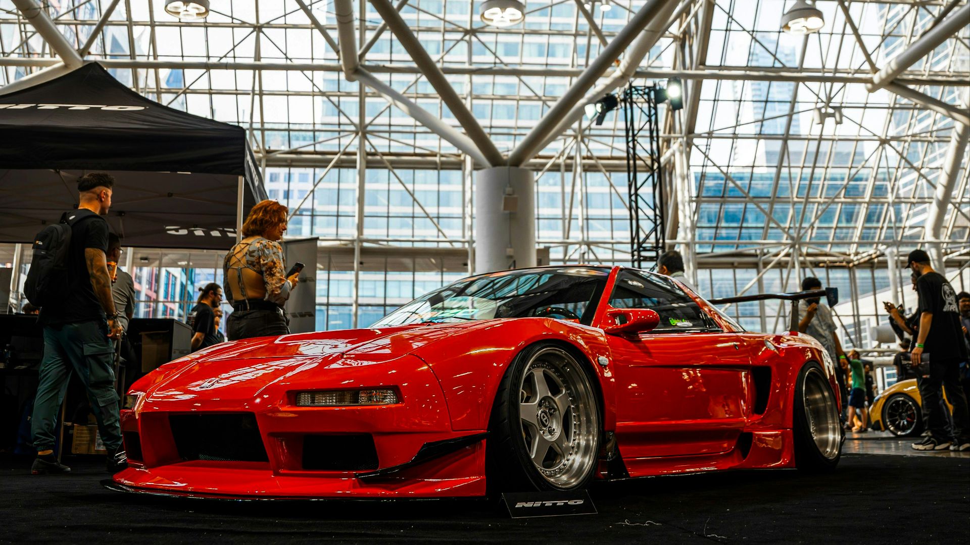A red sports car parked inside of a building