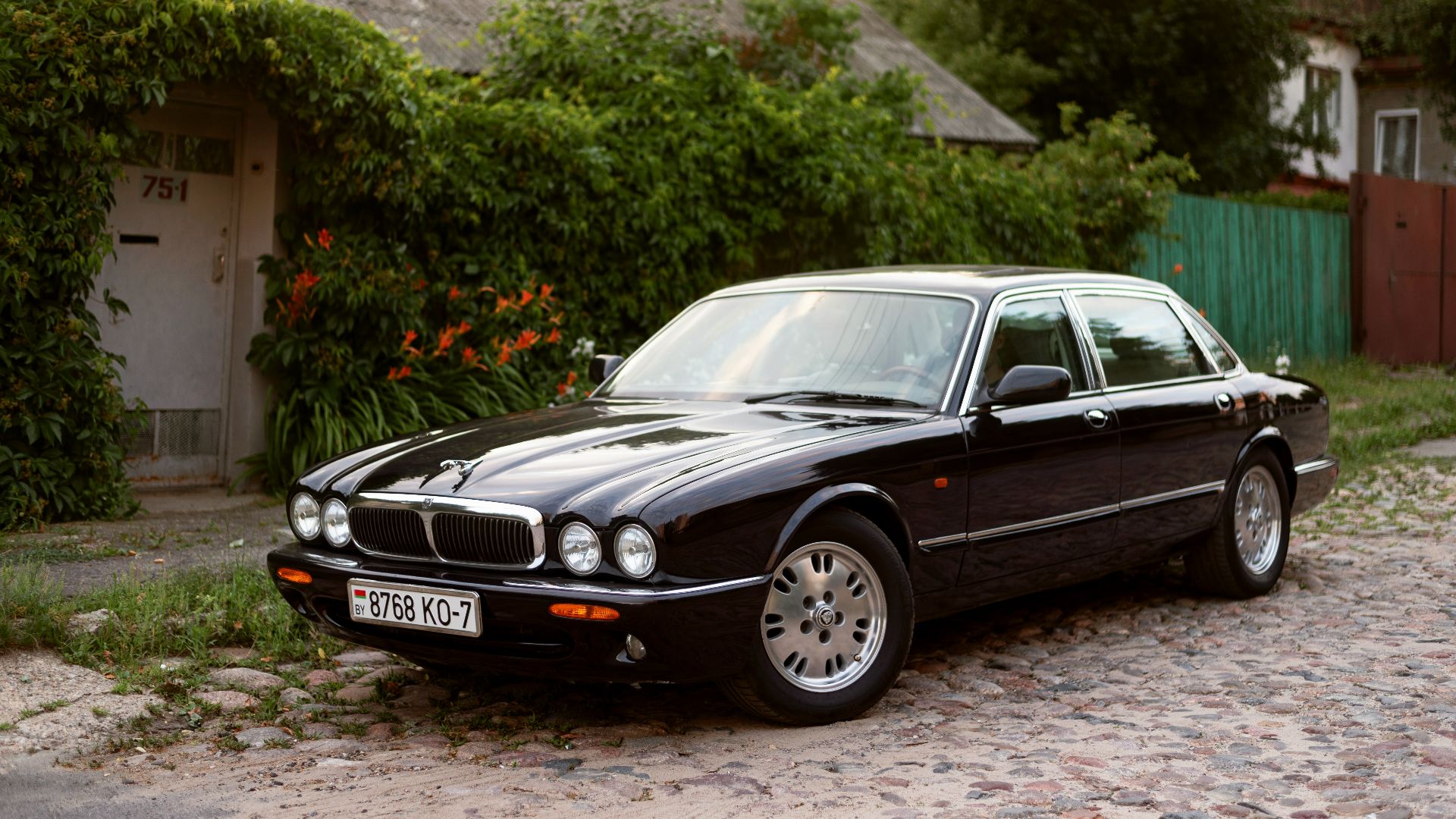 a black car parked in front of a house