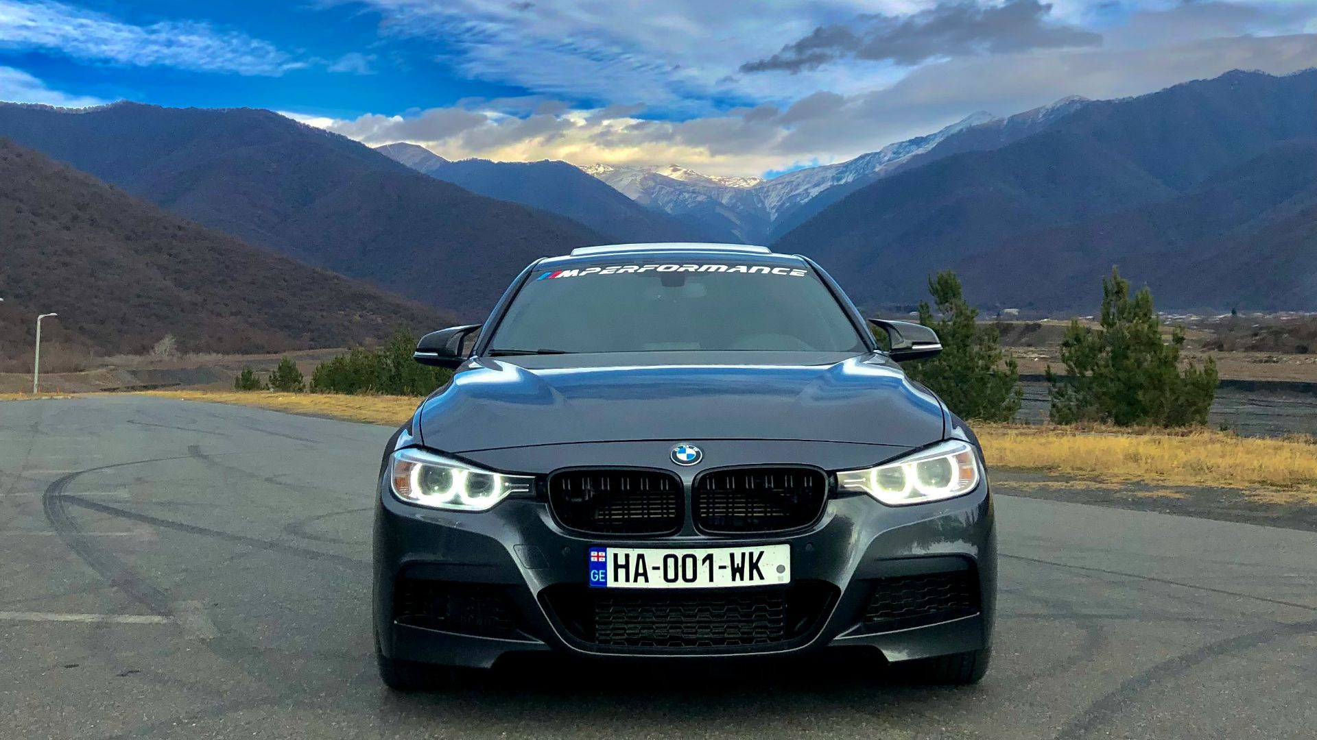 a black car parked on the side of a road