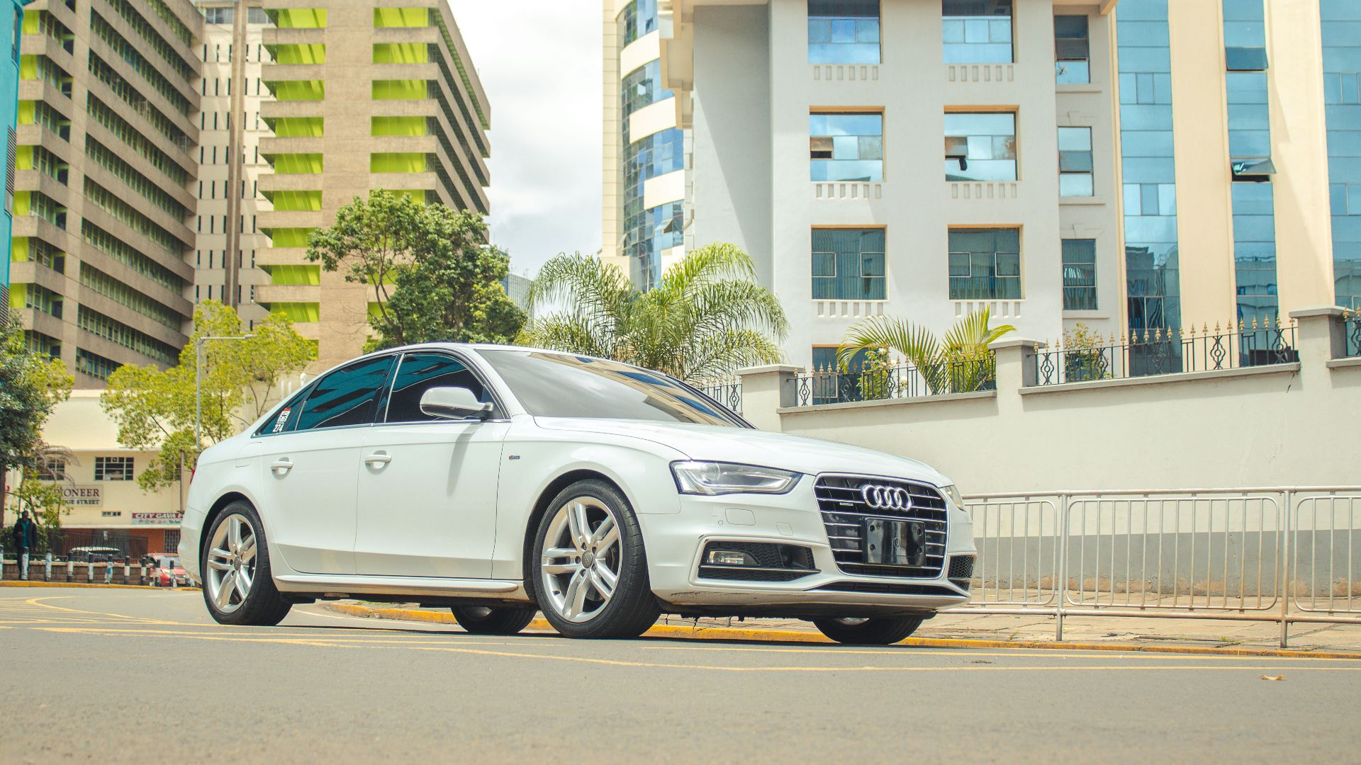 A white car parked on the side of the road