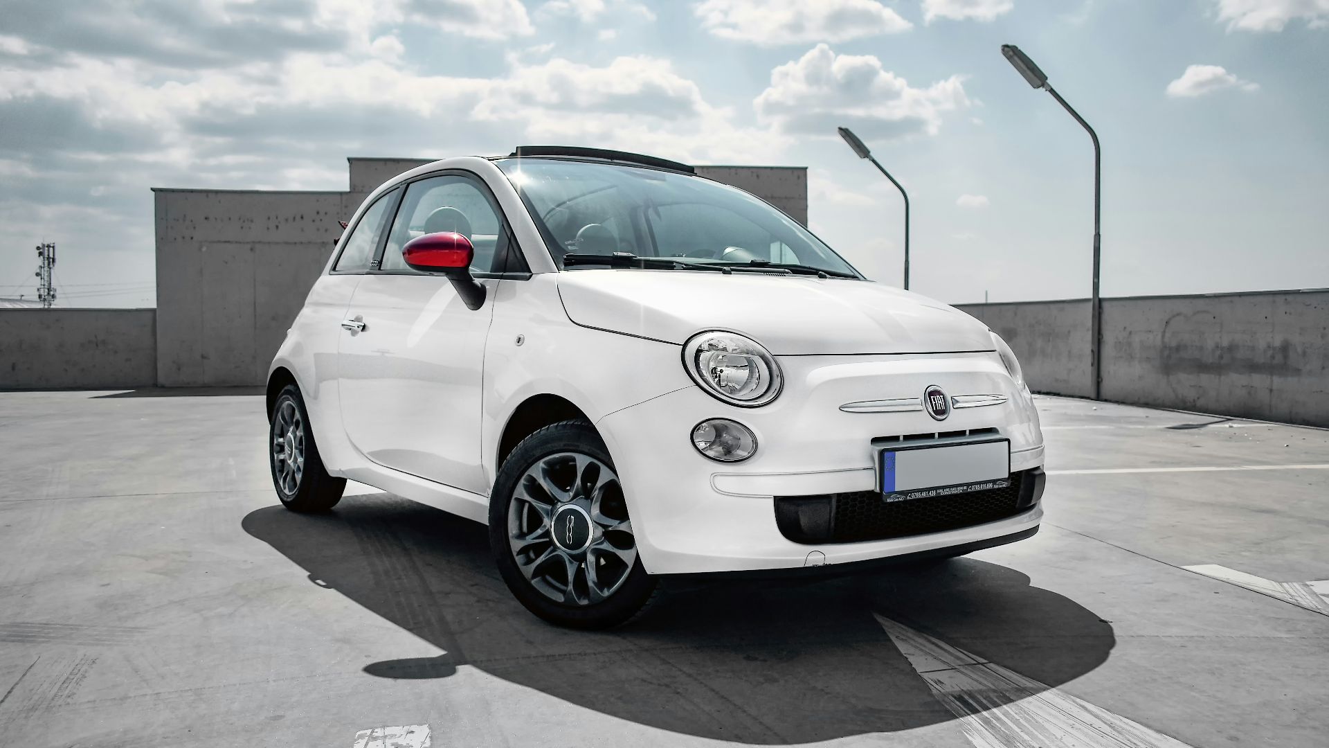 white 3-door hatchback on gray floor