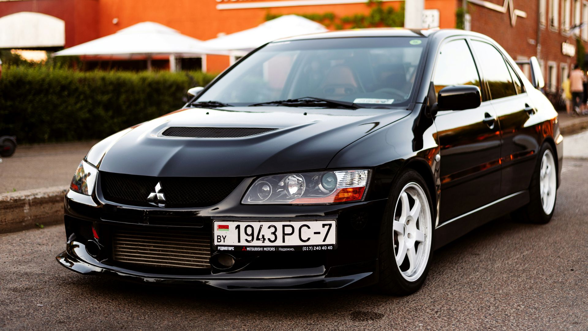 a black car parked on the side of a road