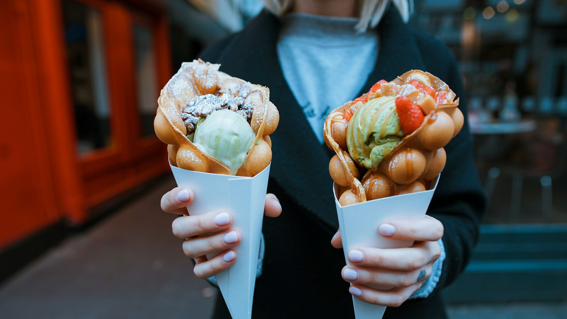 person holding two ice creams