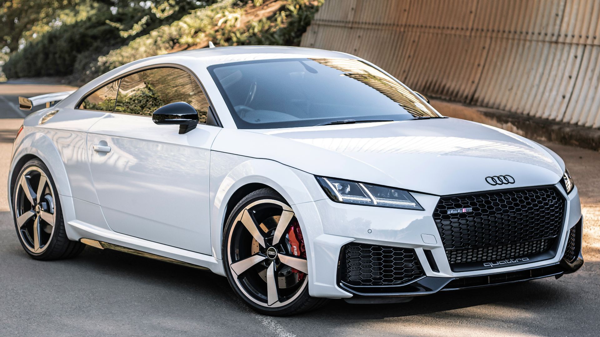 white audi r 8 parked near brown wall