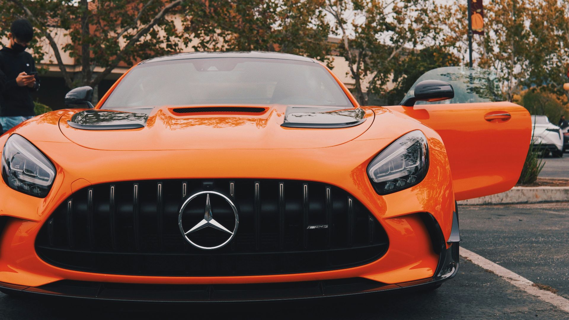 an orange sports car parked in a parking lot