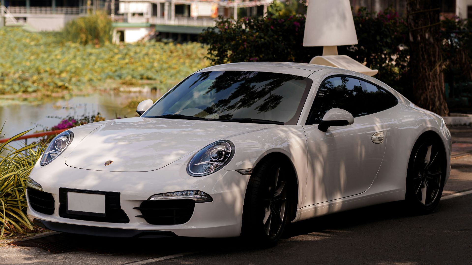 a white sports car parked on the side of the road