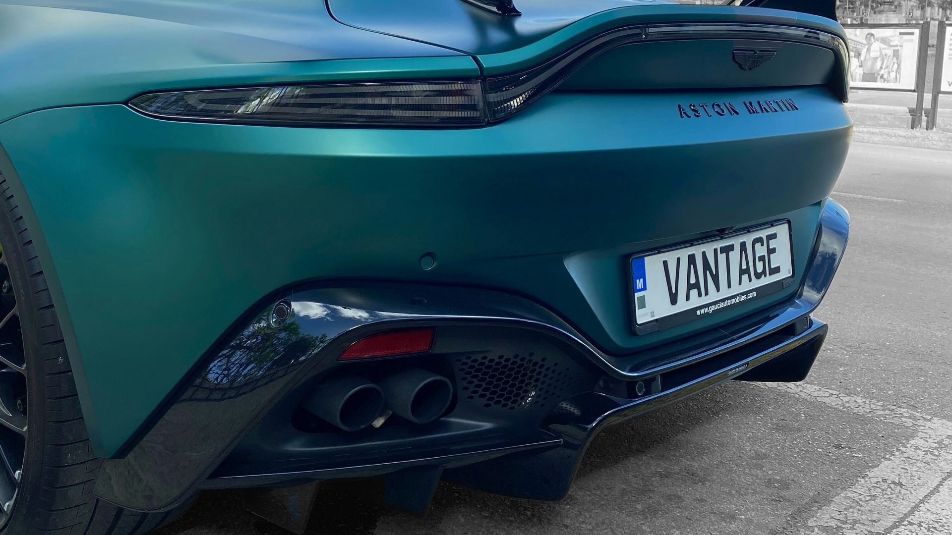 a blue sports car parked on the side of the road