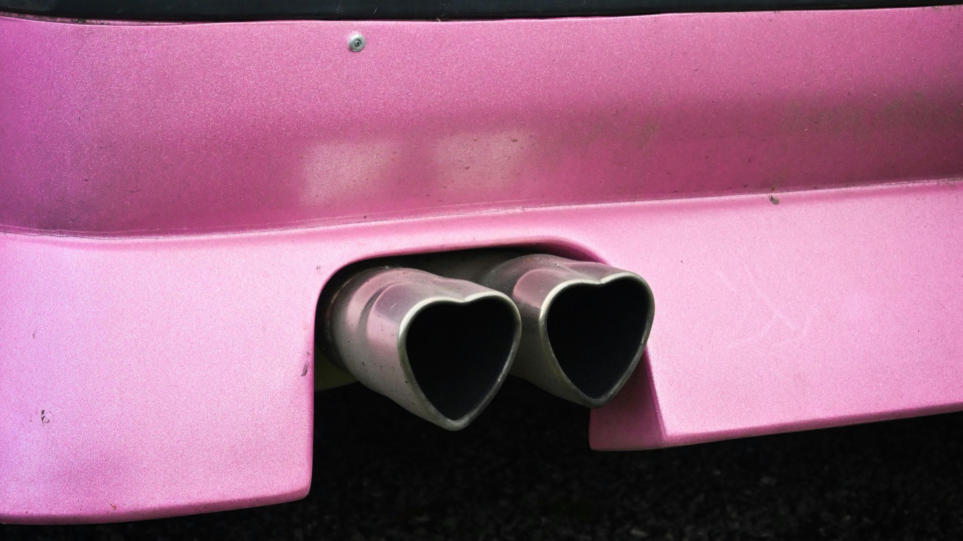 a pink car with a yellow license plate