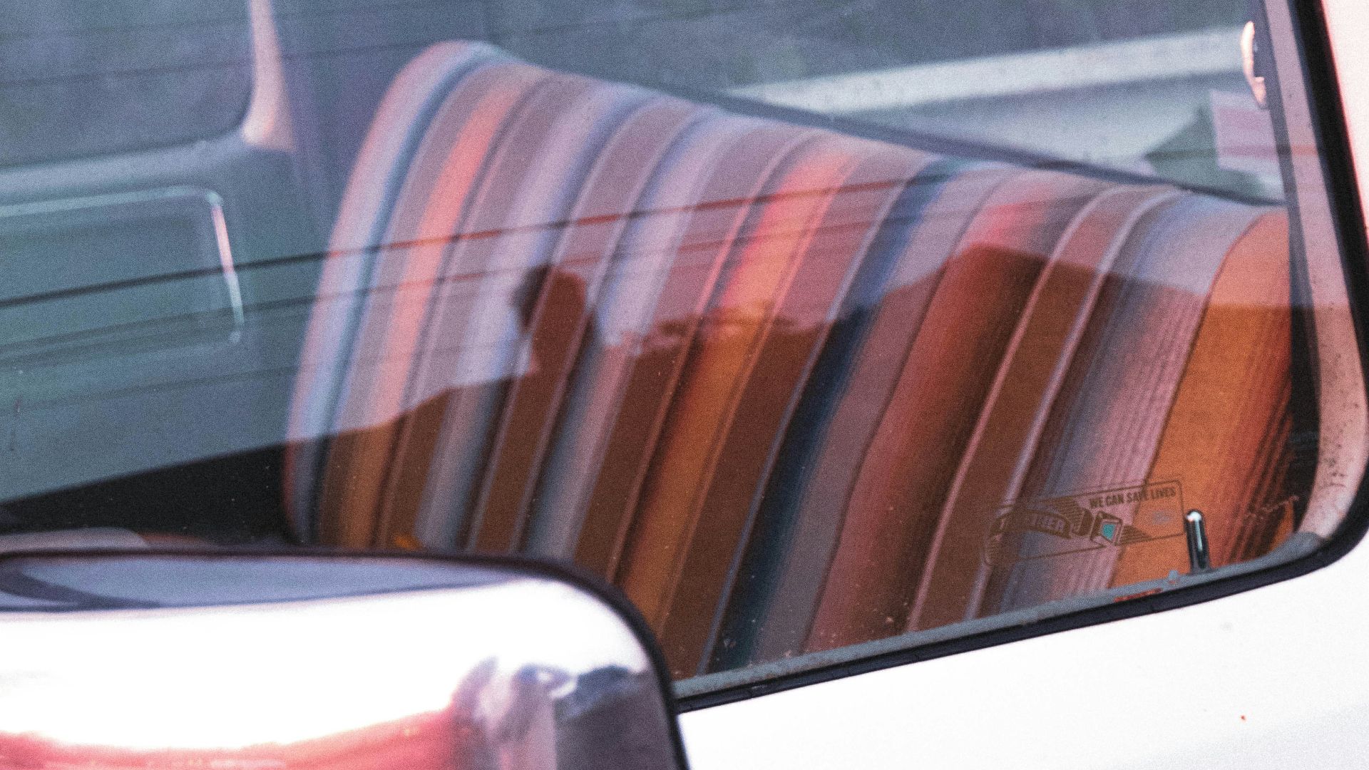 white car door with brown and white striped seat
