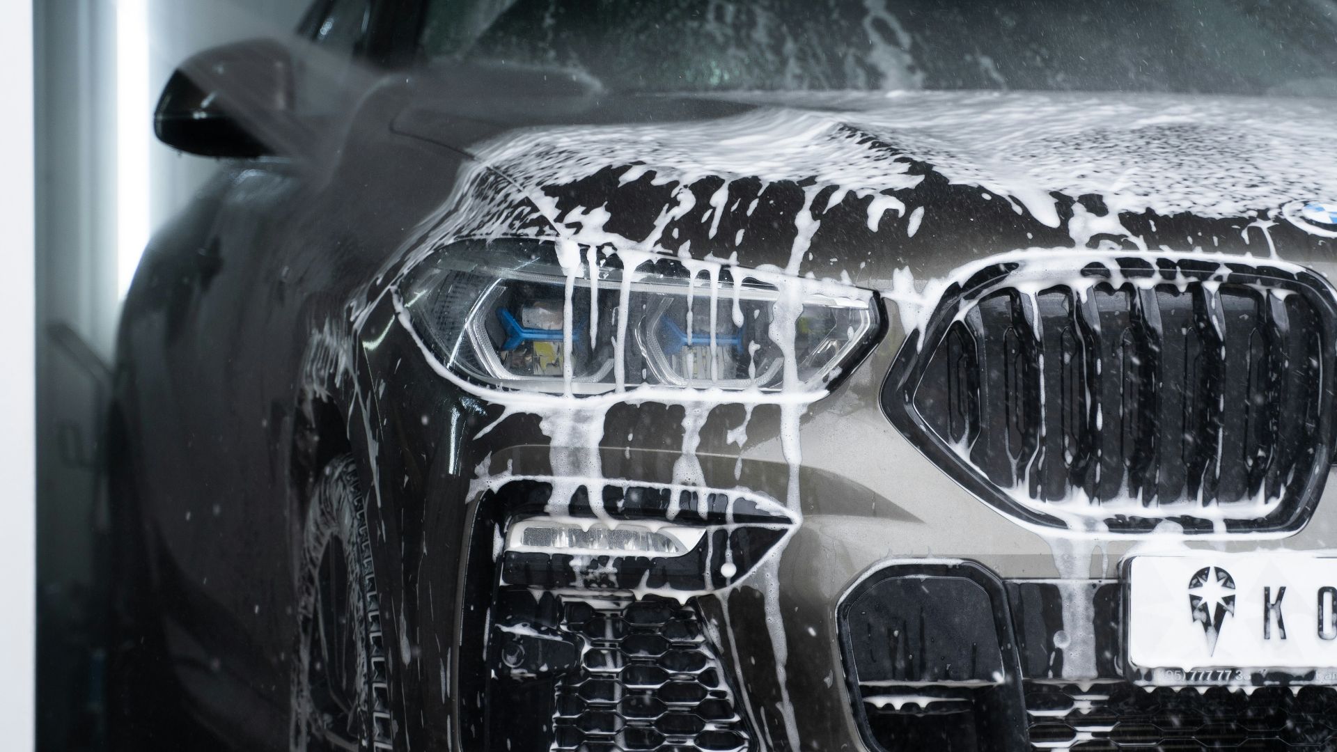 a car is covered in snow in a garage