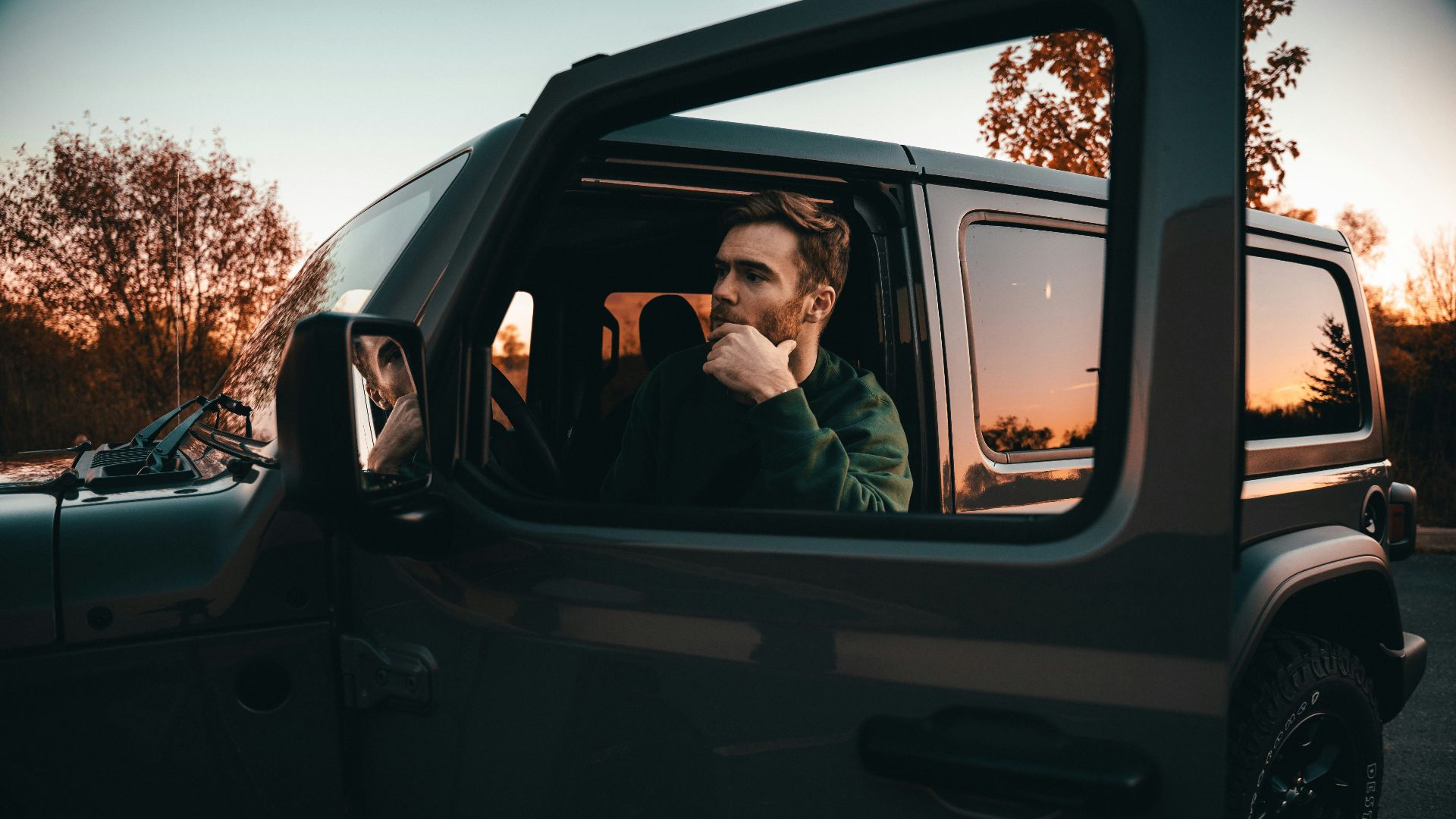 a man sitting in the passenger seat of a car