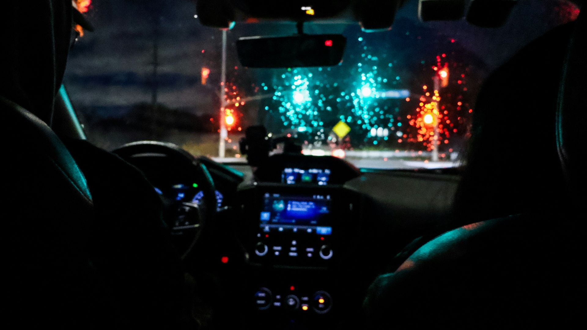 A person driving a car in the dark