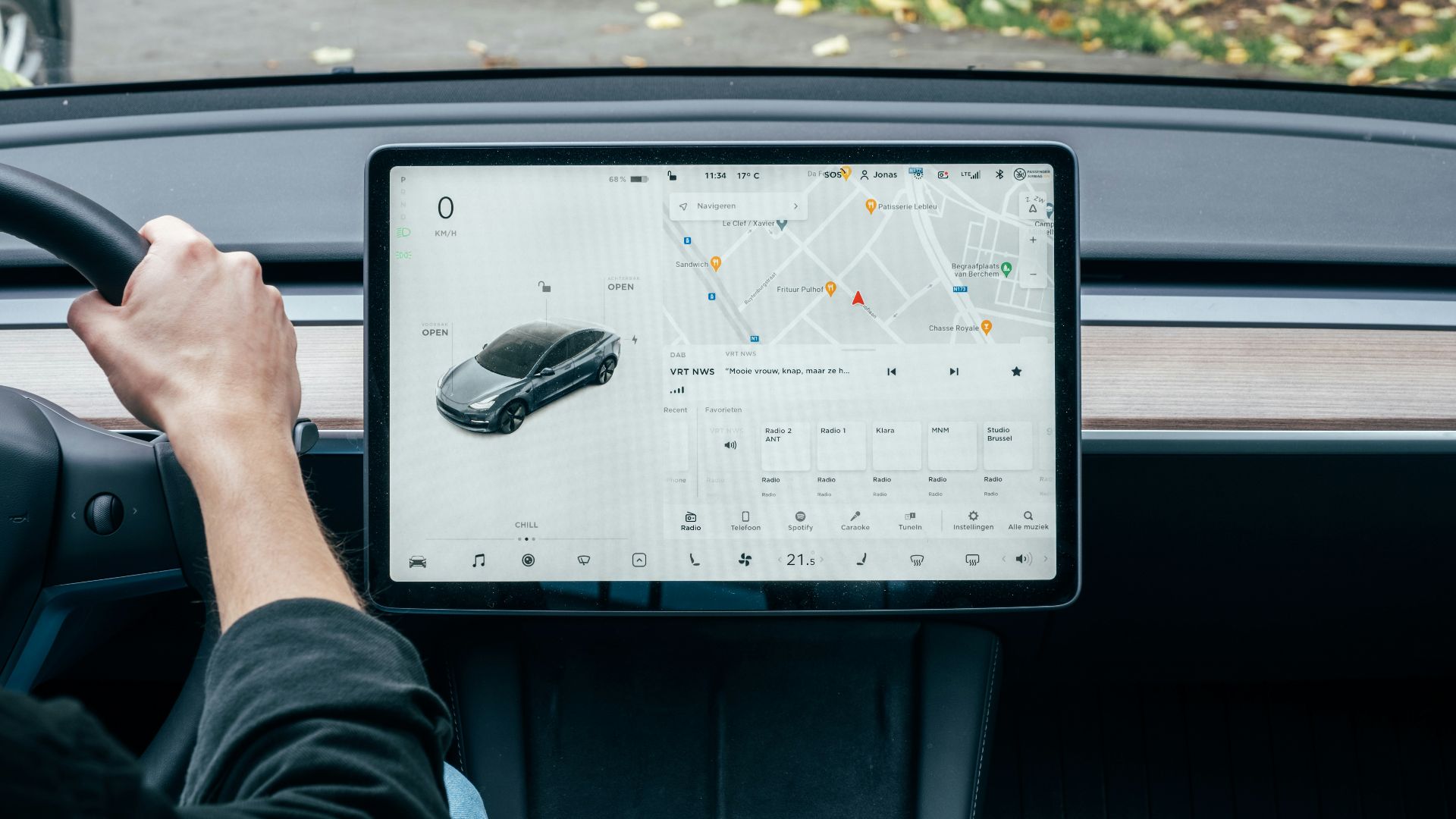 a person driving a car with a computer on the dashboard