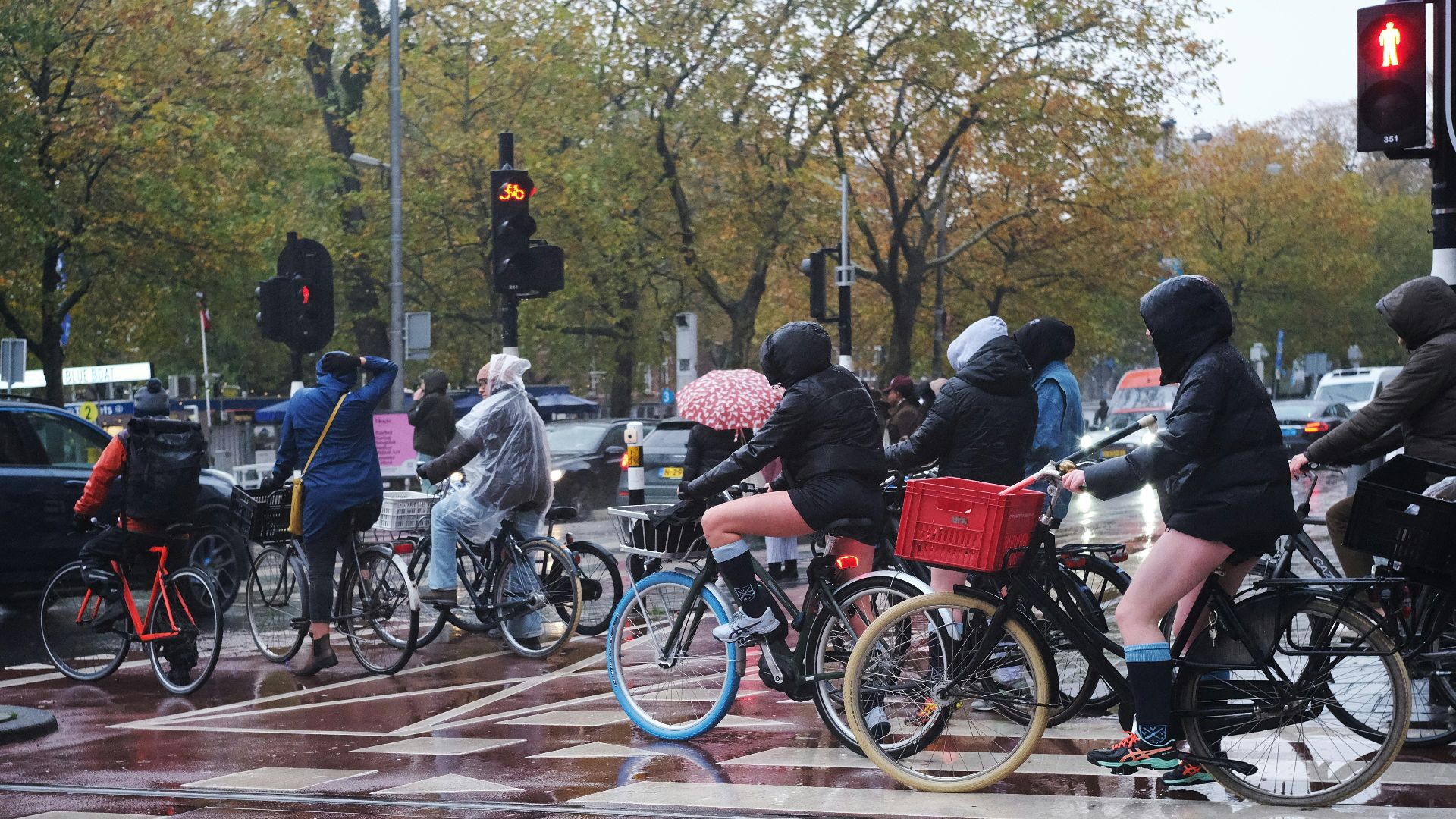 a group of people riding bikes down a street