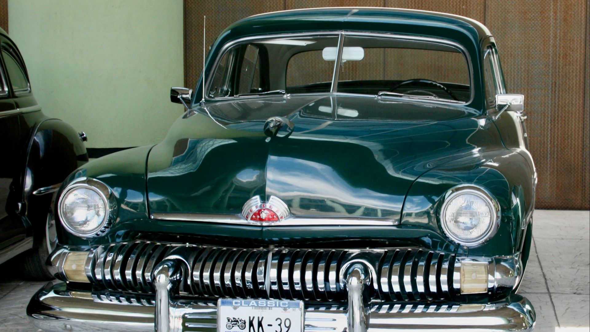 Here is a possible caption: a green vintage car is beautifully displayed.