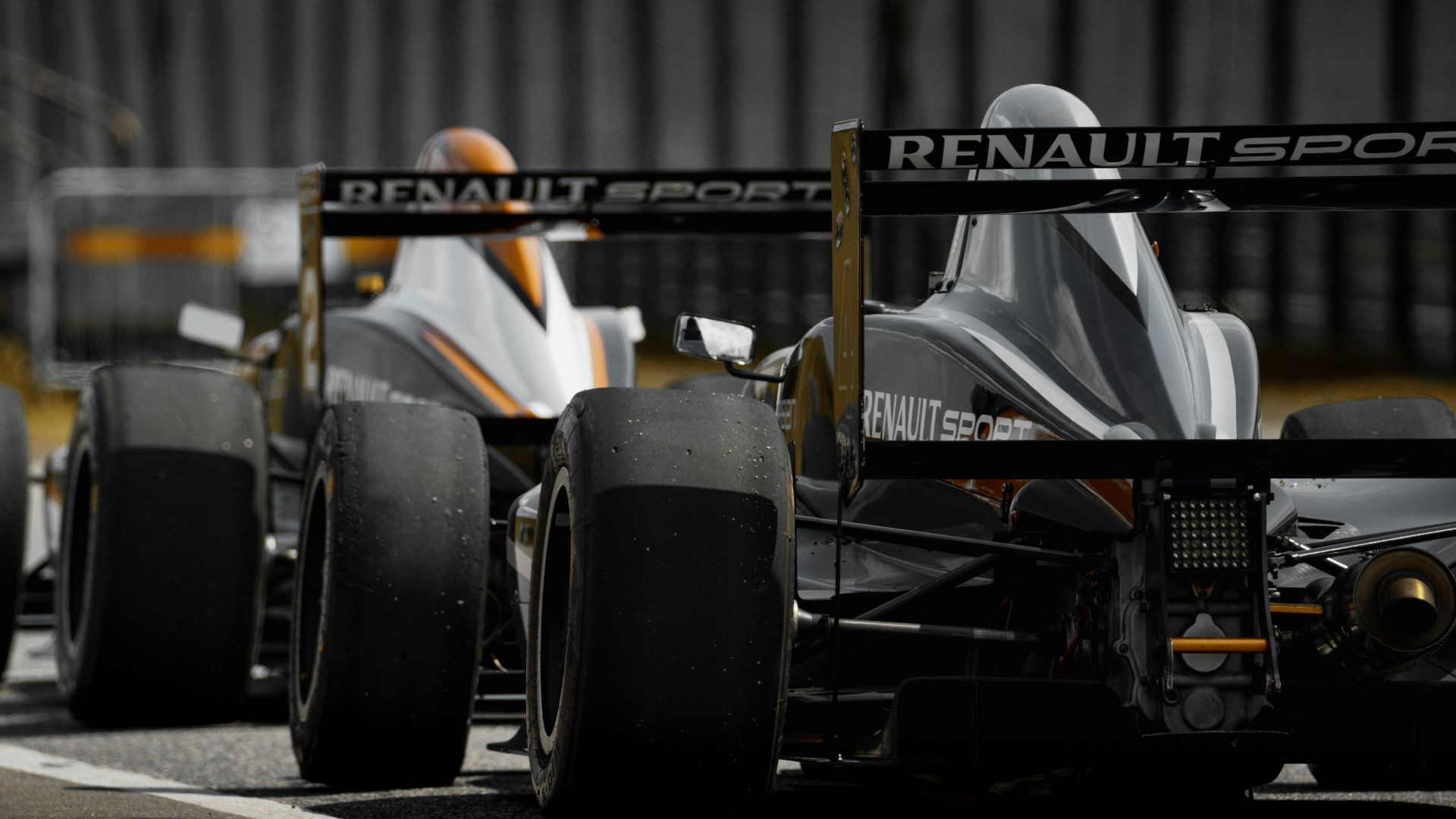 black and yellow f 1 car on road during daytime