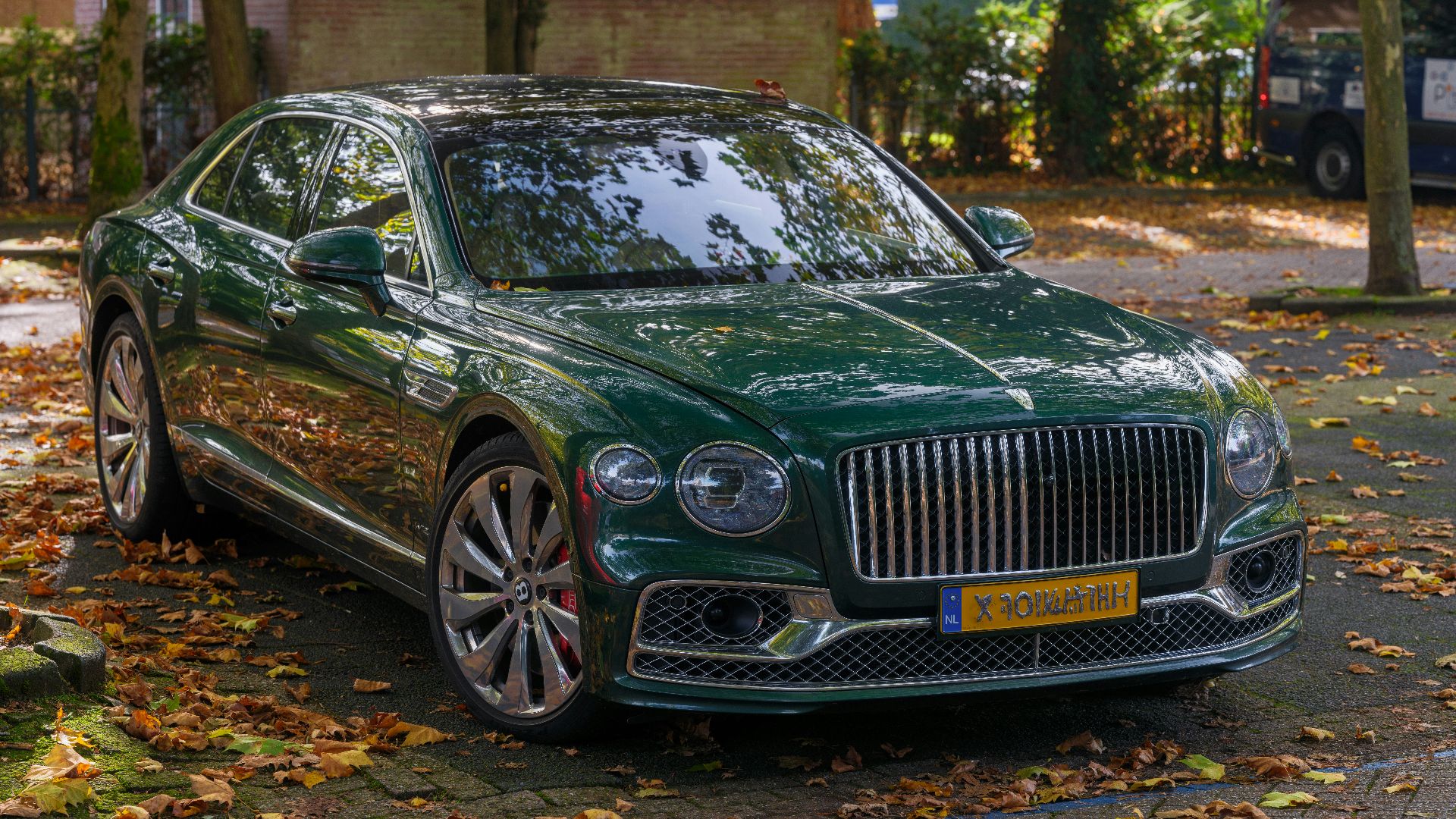 A green car parked on the side of the road